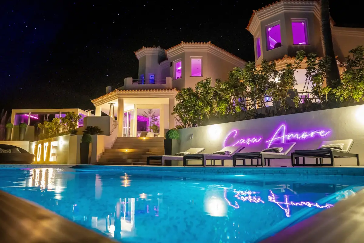 Casa Amore party villa in Costa Adeje, Tenerife, with the pool and terraces lit up at night