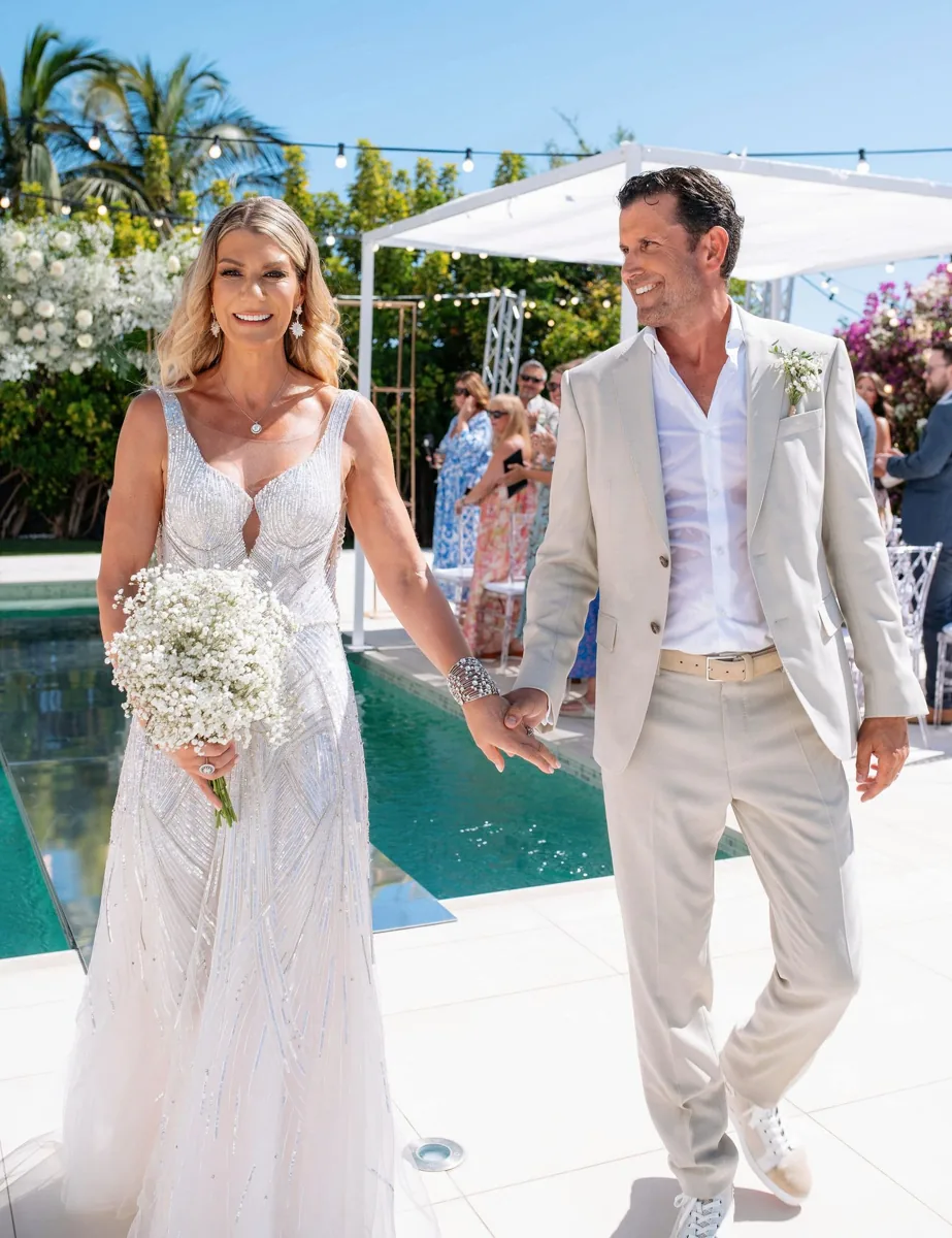 Couple walking hand in hand up the poolside aisle at Casa Amore Tenerife