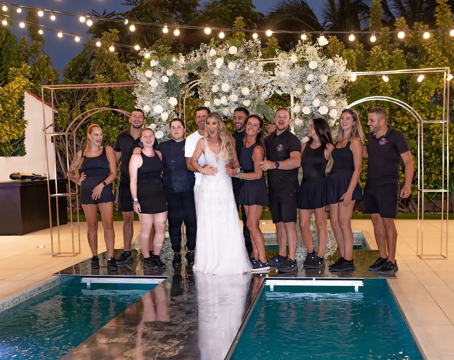 Wedding party on the illuminated pool walkway beneath festoon lights at Casa Amore Tenerife